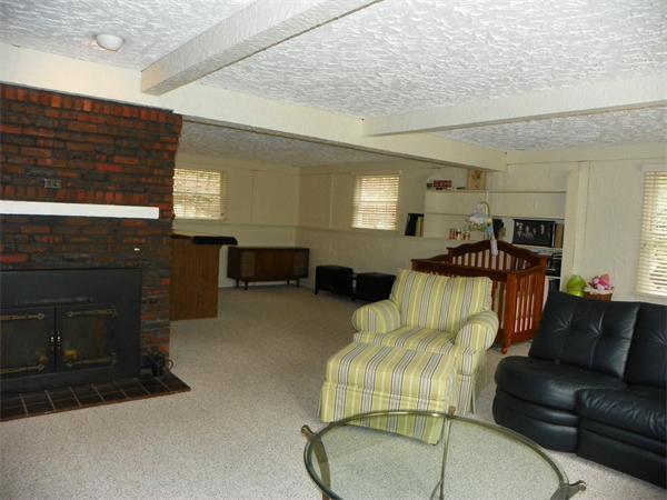 50 Algonquin Road Canton, MA 02021 - Photo 18 of 26 a living room with furniture a window and a fireplace