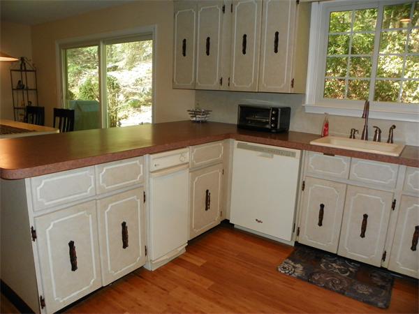 50 Algonquin Road Canton, MA 02021 - Photo 8 of 26 a kitchen with white cabinets and white appliances