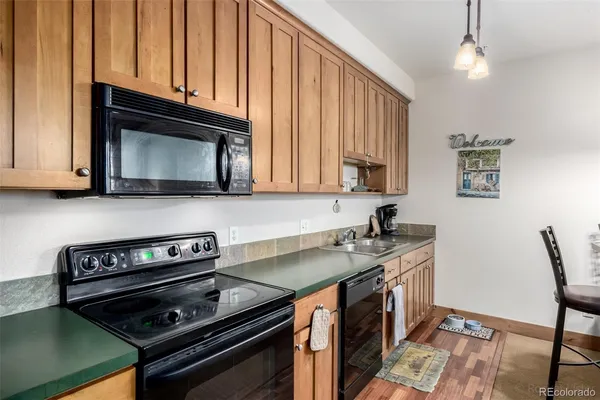 a kitchen with stainless steel appliances a stove a microwave and cabinets