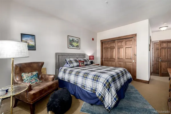 a bedroom with a bed and a lamp on table