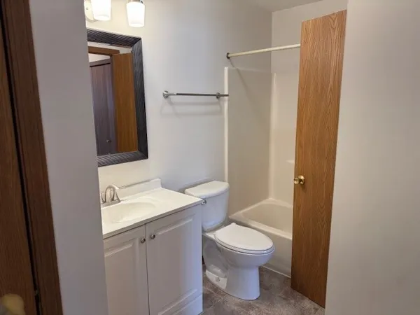 a bathroom with a toilet sink and a mirror
