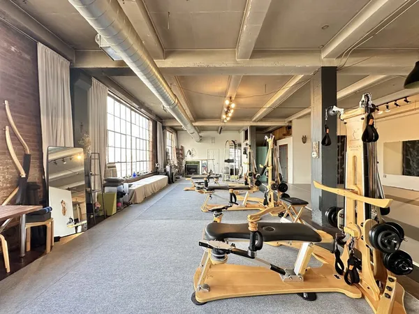 a living room with furniture gym equipment and a large window
