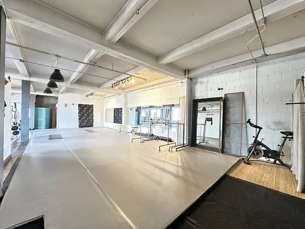 a room with gym equipment and a table