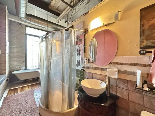 a bathroom with a sink toilet and mirror