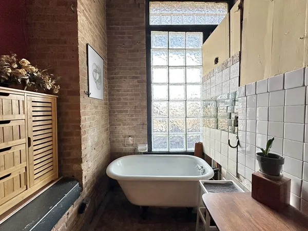 a bathroom with a sink a bathtub and window