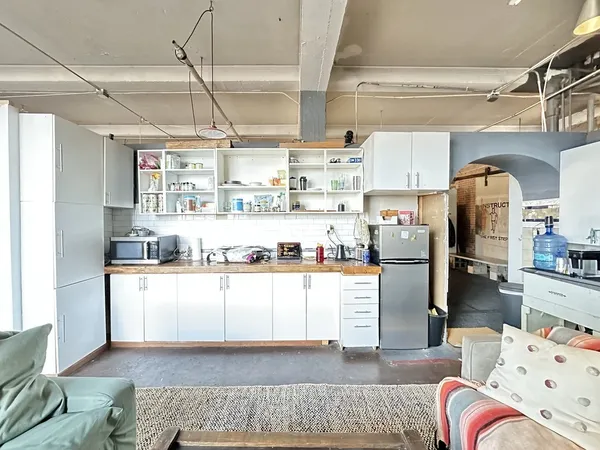 a kitchen with stainless steel appliances kitchen island granite countertop a refrigerator and microwave