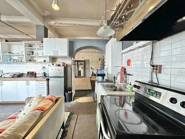a kitchen with furniture and a fireplace