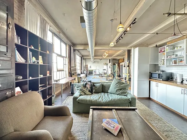 a living room with furniture and a kitchen