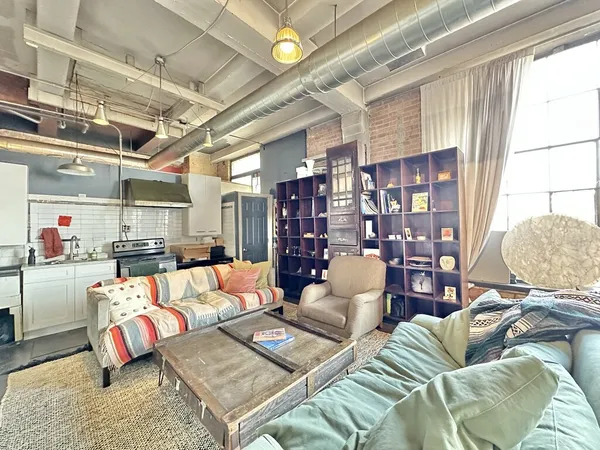 a living room with furniture and a chandelier