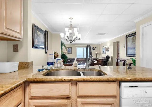 a kitchen with kitchen island a sink and chandelier