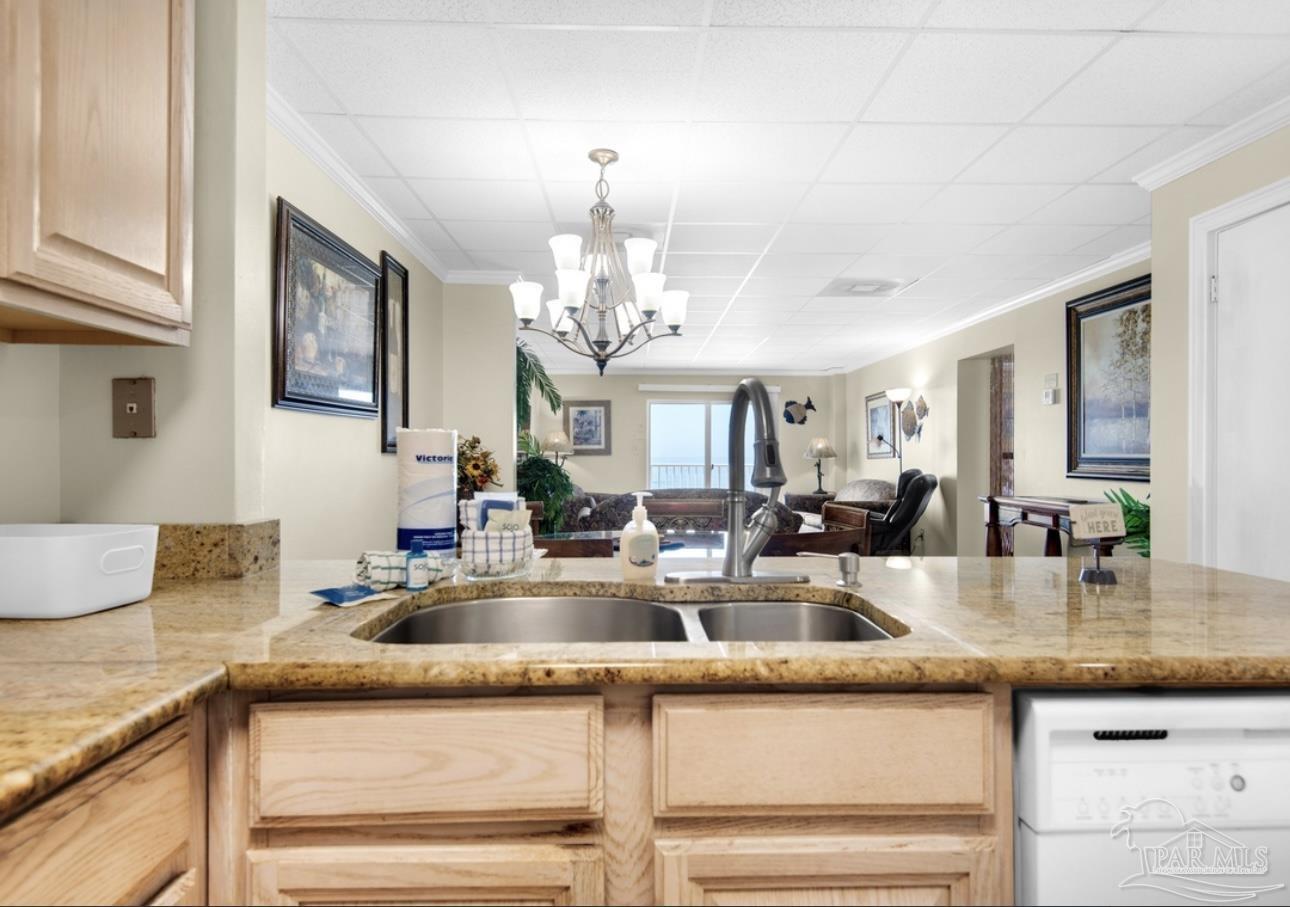 999 Fort Pickens Road, Unit 506 Pensacola Beach, FL 32561 - Photo 2 of 8 a kitchen with kitchen island a sink and chandelier