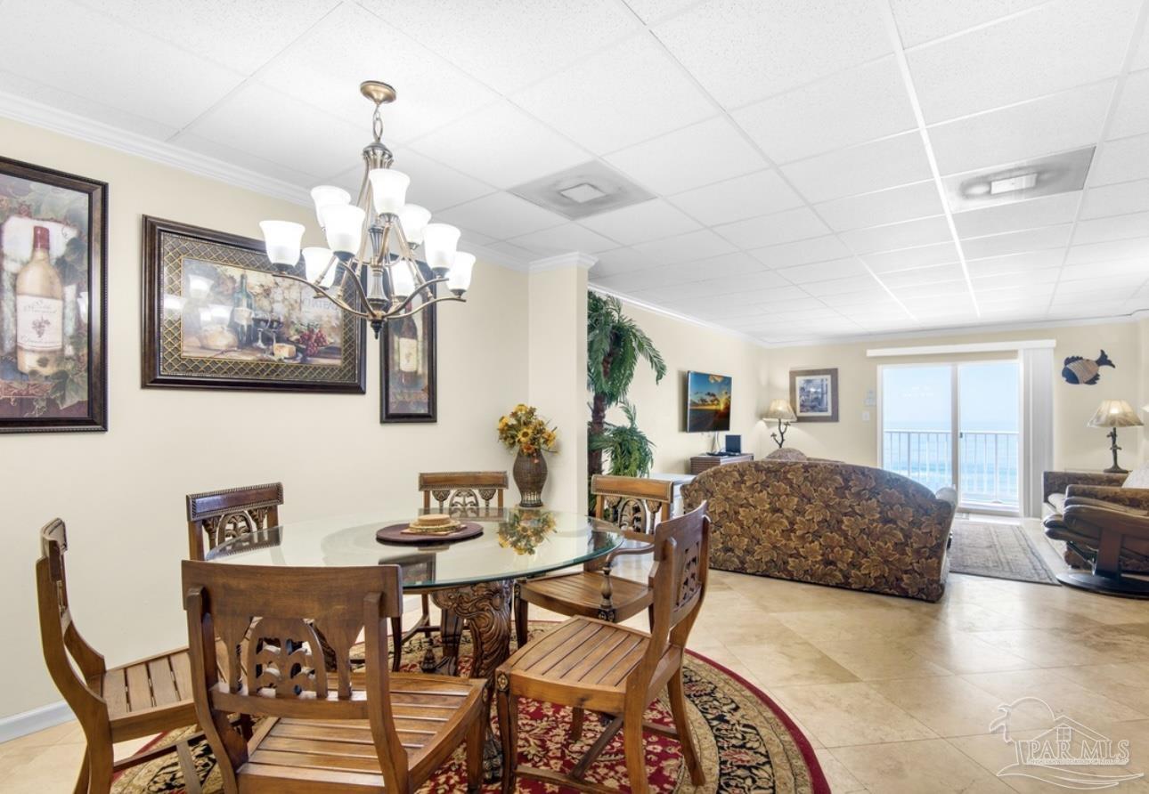 999 Fort Pickens Road, Unit 506 Pensacola Beach, FL 32561 - Photo 5 of 8 a living room with furniture and a chandelier