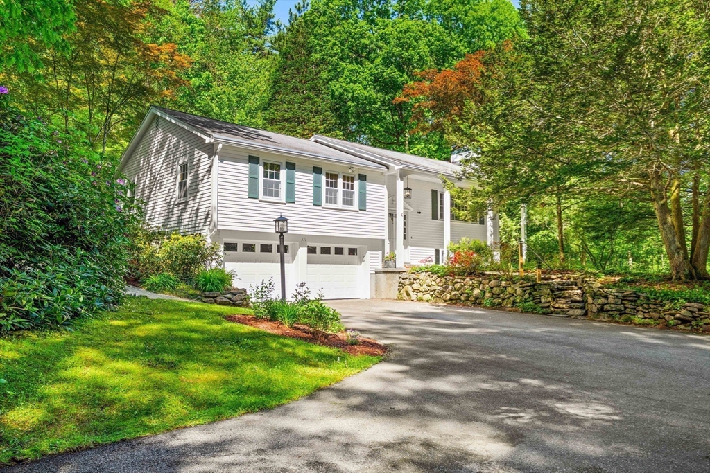 371 Longley Road Groton, MA 01450 - Photo 31 of 33 a front view of a house with a garden and trees