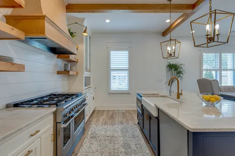 a kitchen with stainless steel appliances granite countertop a sink and stove