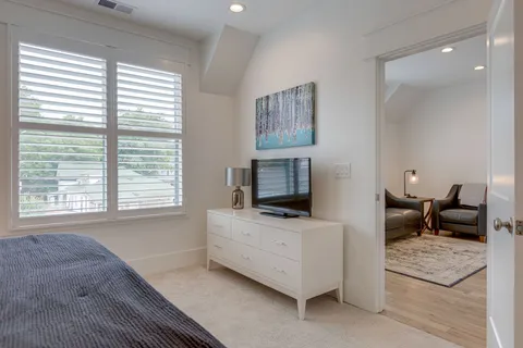 a bathroom with a granite countertop double vanity and mirror