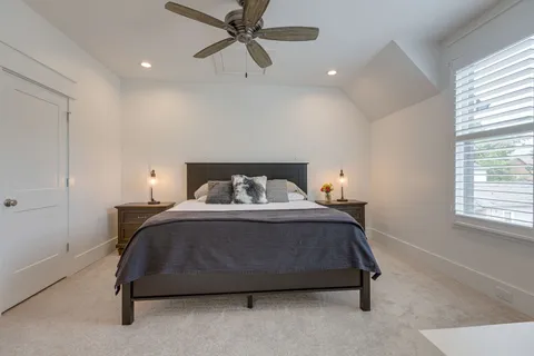 a bathroom with a granite countertop toilet sink and mirror