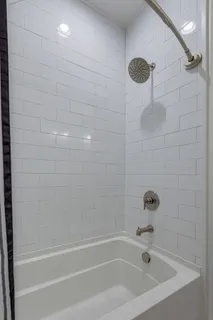 a view of a balcony with wooden floor and fence