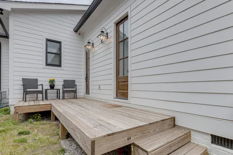 a front view of a house with a garden and plants