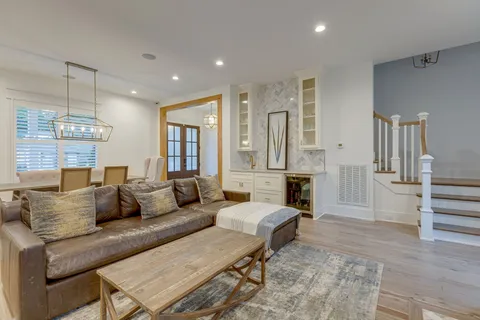 a living room with furniture and a chandelier