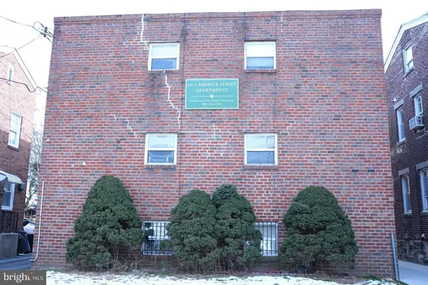 a brick building with a yard