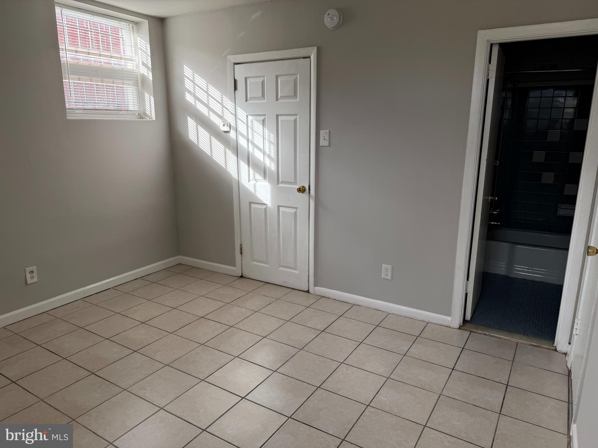 5711 Erdrick Street, Unit 3 Philadelphia, PA 19135 - Photo 12 of 18 an empty room with windows