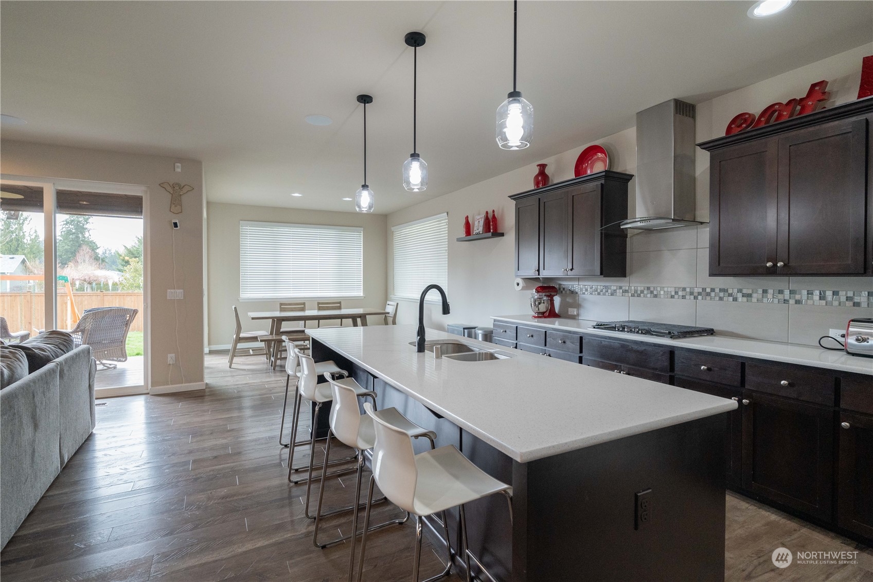 4731 Rosa Court Lacey, WA 98503 - Photo 5 of 31 a kitchen with stainless steel appliances granite countertop a sink a stove and a wooden floors