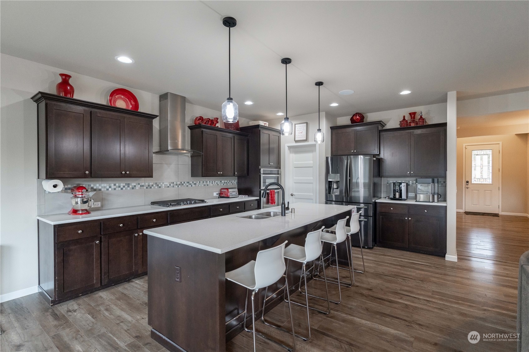 4731 Rosa Court Lacey, WA 98503 - Photo 7 of 31 a kitchen with stainless steel appliances a stove a sink a refrigerator and chairs