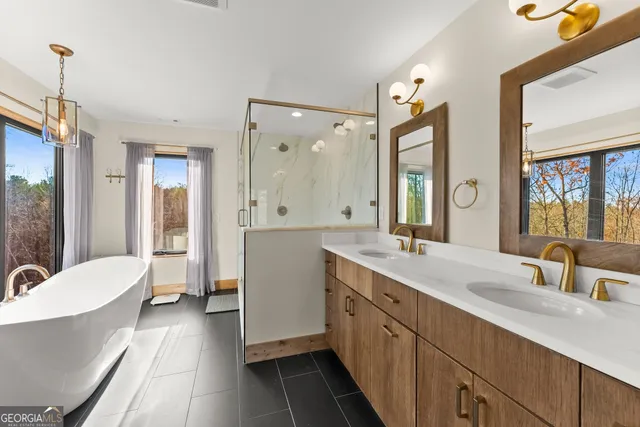 a bathroom with a shower a toilet and a bathtub