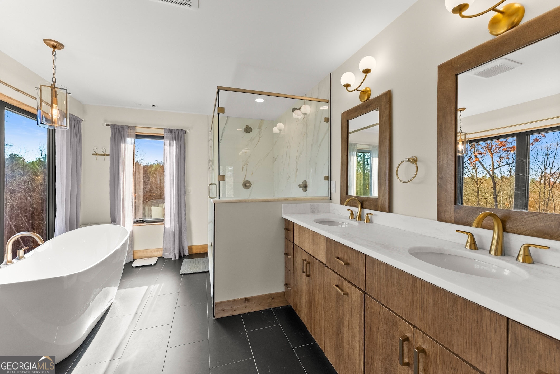 147 Jess Hunt Road West Cleveland, GA 30528 - Photo 34 of 69 a spacious bathroom with a double vanity sink a large mirror and a bathtub