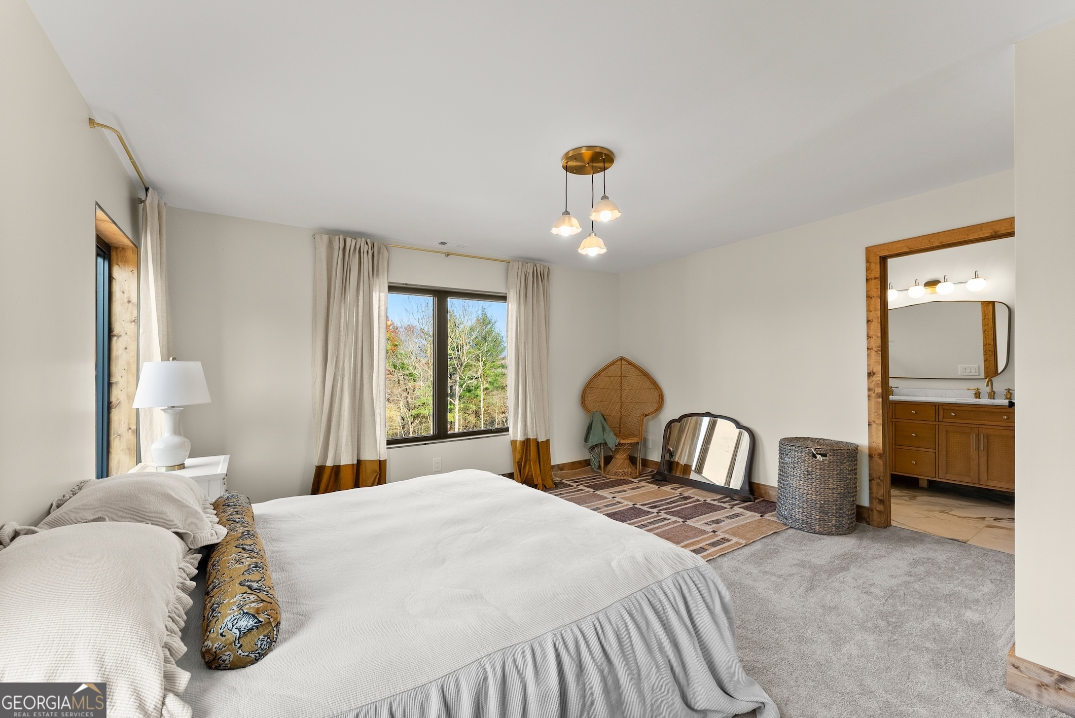 147 Jess Hunt Road West Cleveland, GA 30528 - Photo 40 of 69 a bedroom with a bed and a chandelier