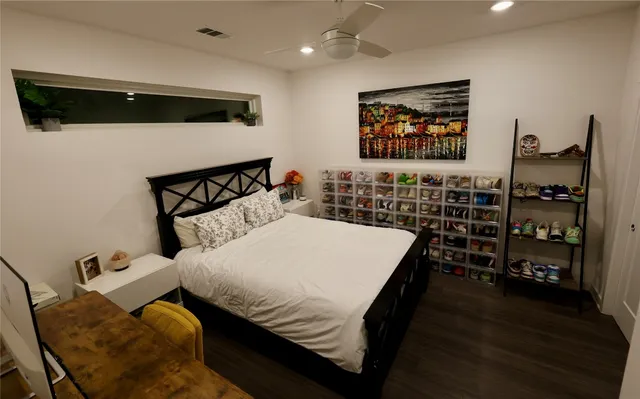 a bed sitting in a bedroom next to a book shelf