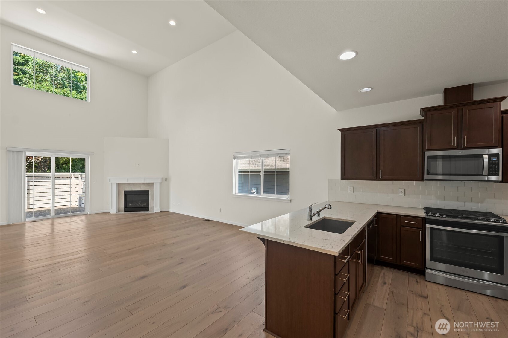 1080 East Old Ranch Road, Unit A1A2 Allyn, WA 98524 - Photo 12 of 35 a kitchen with sink cabinets and microwave