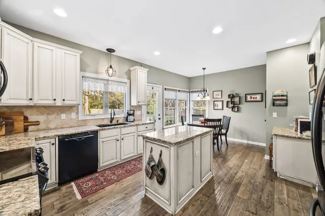 a kitchen with stainless steel appliances granite countertop a stove and a refrigerator