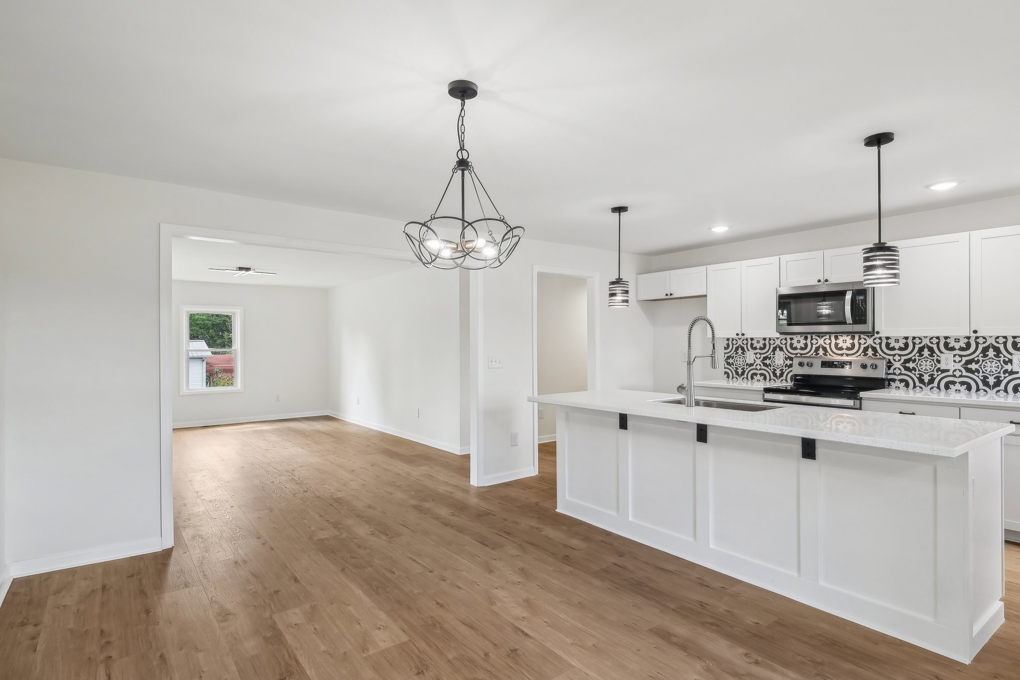 876 Ford Road White Bluff, TN 37187 - Photo 11 of 56 a kitchen with stainless steel appliances granite countertop a sink a stove and white cabinets