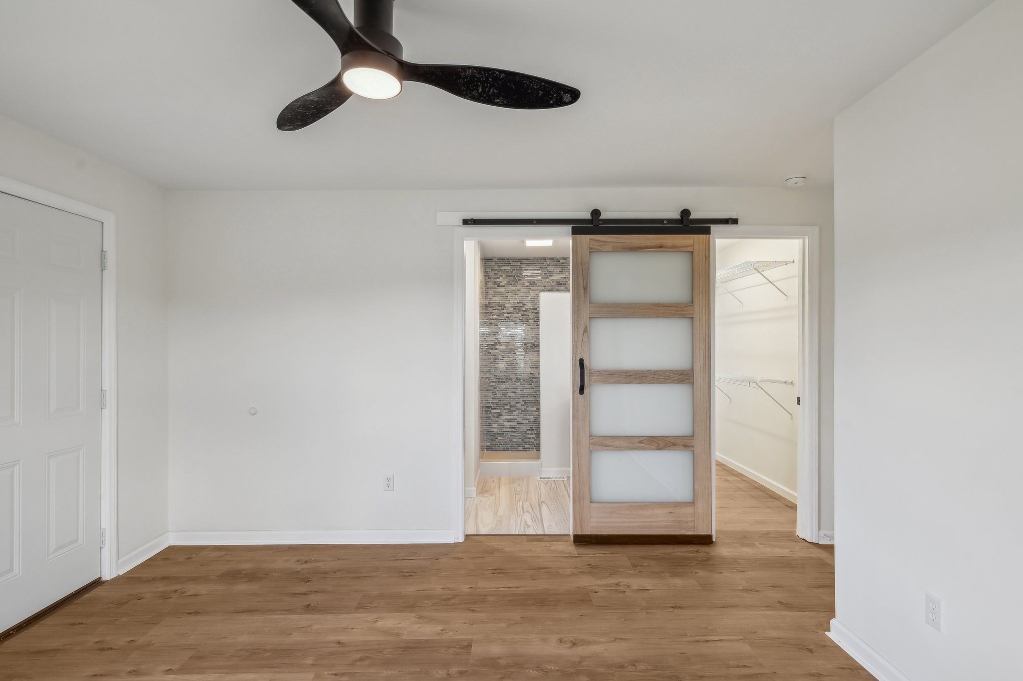 876 Ford Road White Bluff, TN 37187 - Photo 16 of 56 an empty room with wooden floor closet and chandelier fan