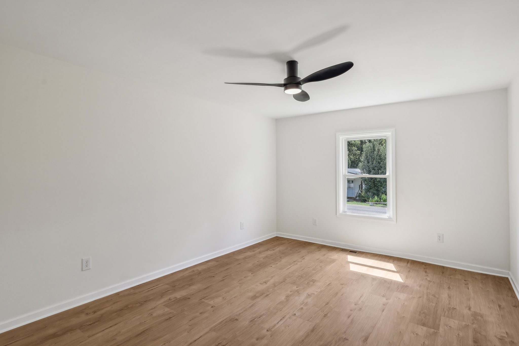 876 Ford Road White Bluff, TN 37187 - Photo 21 of 56 an empty room with a window and a ceiling fan