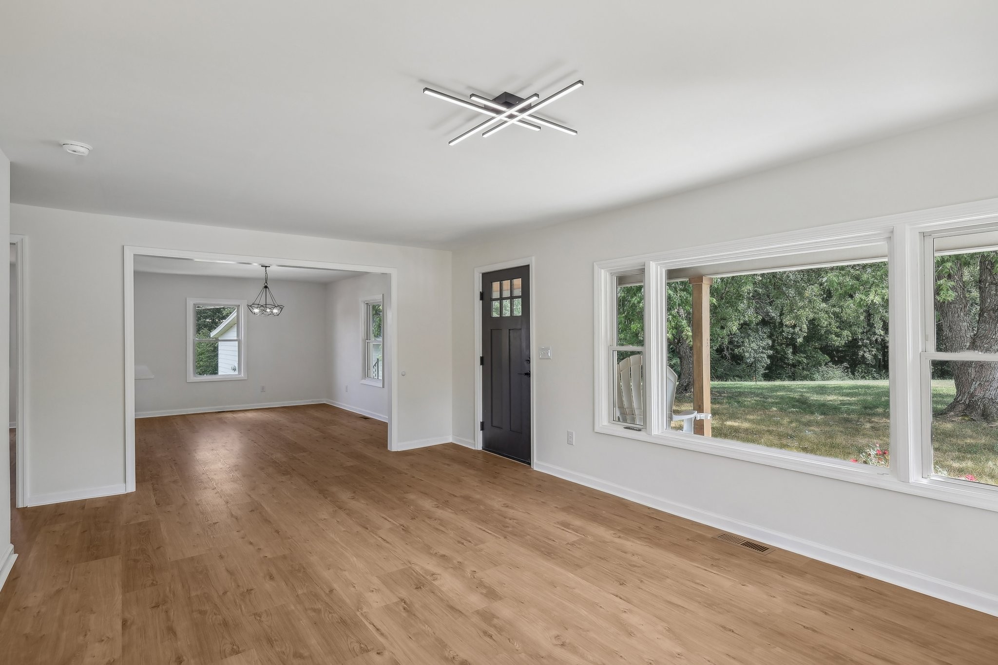 876 Ford Road White Bluff, TN 37187 - Photo 7 of 56 a view of an empty room with a window and wooden floor