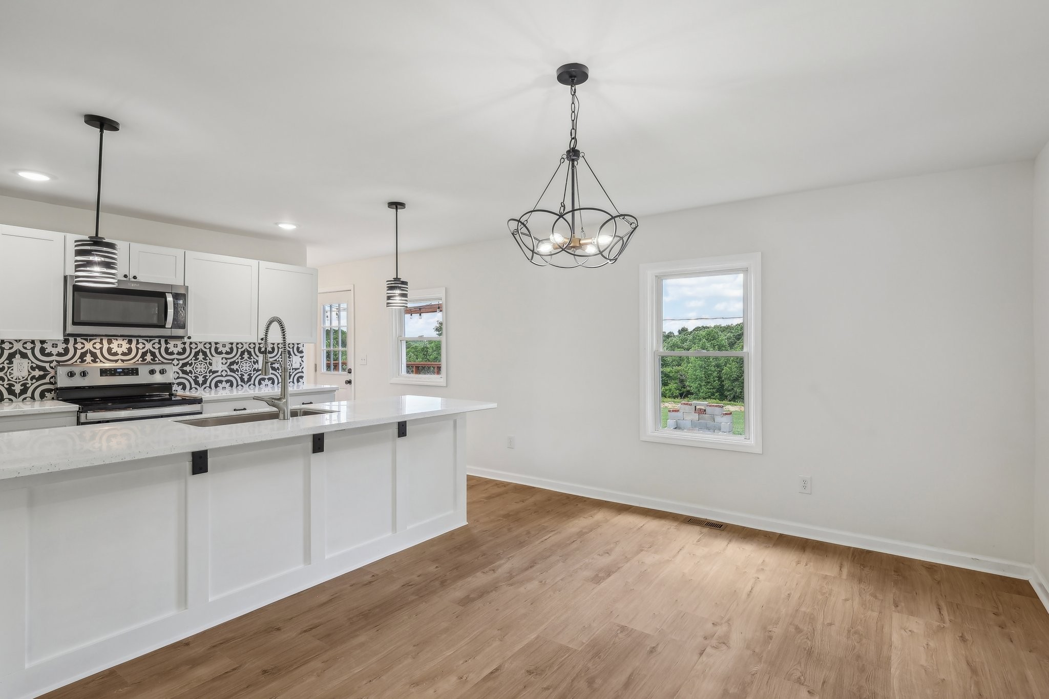 876 Ford Road White Bluff, TN 37187 - Photo 8 of 56 a kitchen with stainless steel appliances granite countertop a sink a stove and a wooden floors