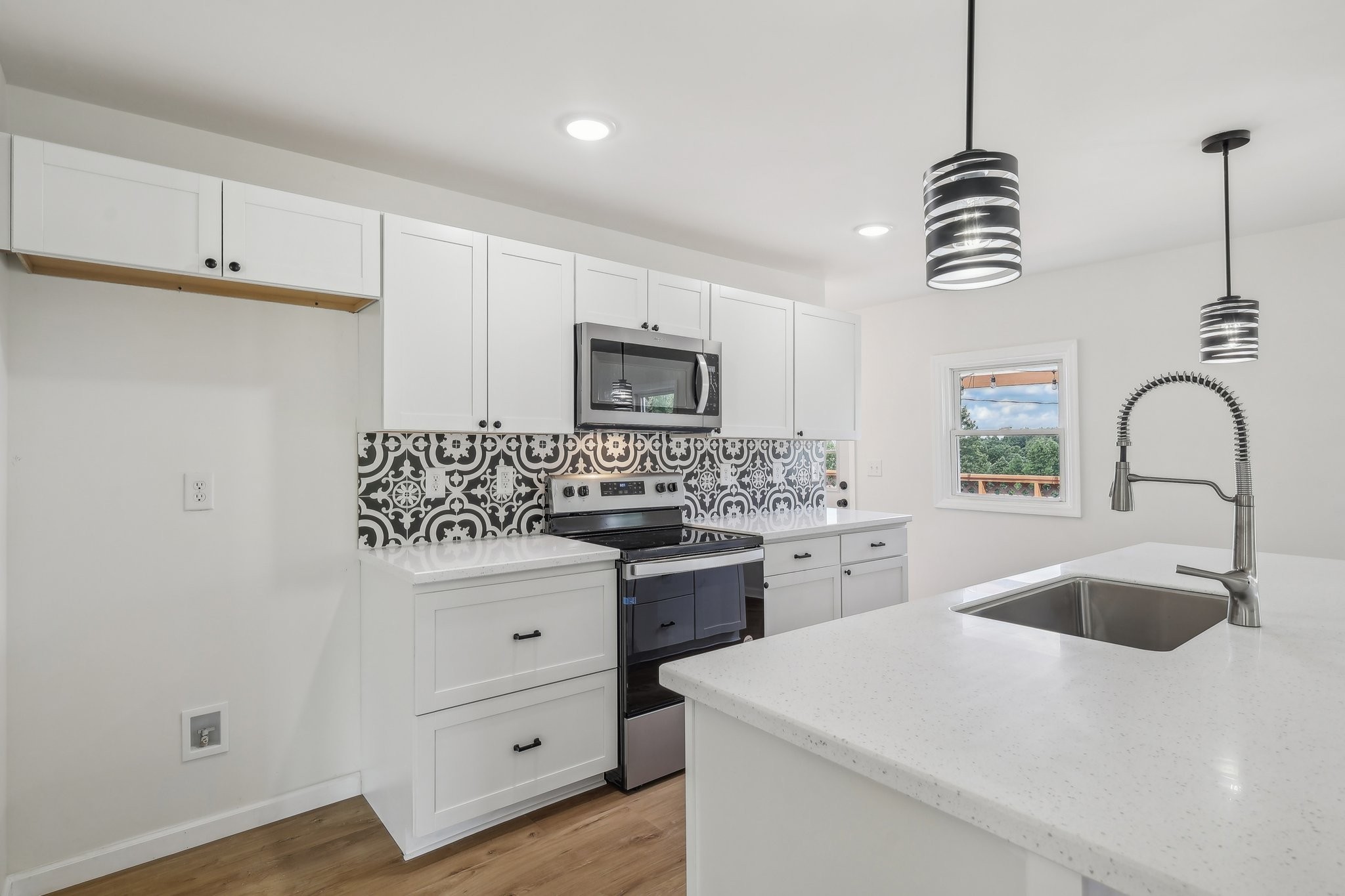 876 Ford Road White Bluff, TN 37187 - Photo 9 of 56 a kitchen with white cabinets stainless steel appliances and sink