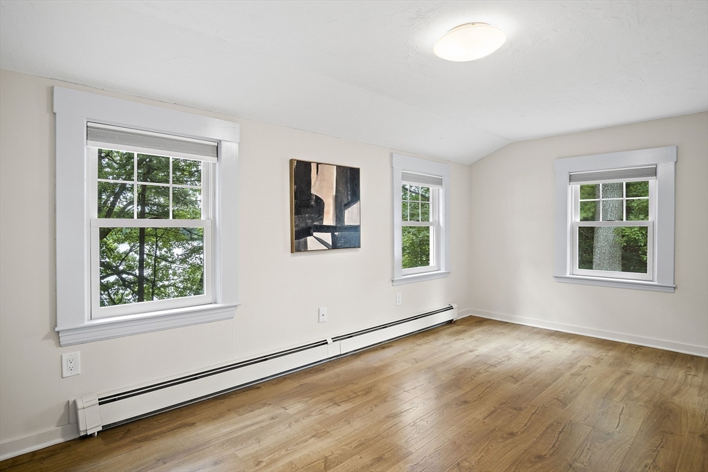 80 Evergreen Road Natick, MA 01760 - Photo 13 of 39 an empty room with wooden floor and windows
