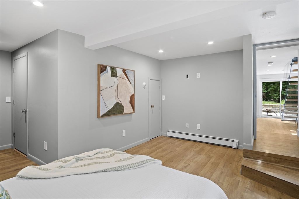 80 Evergreen Road Natick, MA 01760 - Photo 20 of 39 a bedroom with a bed and glass door