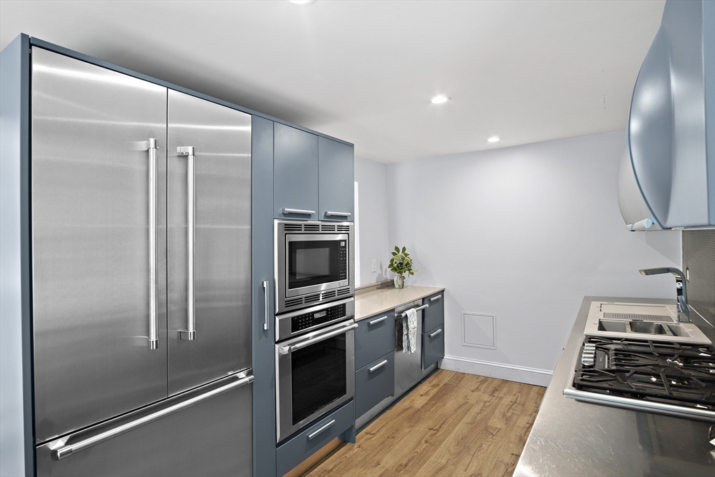 80 Evergreen Road Natick, MA 01760 - Photo 22 of 39 a kitchen with kitchen island a counter appliances and cabinets