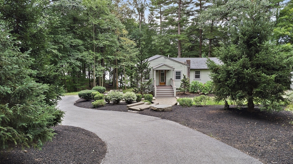 80 Evergreen Road Natick, MA 01760 - Photo 27 of 39 a front view of a house with a yard and garage