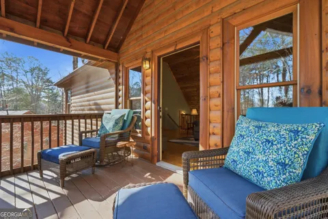 a balcony with furniture and a potted plant