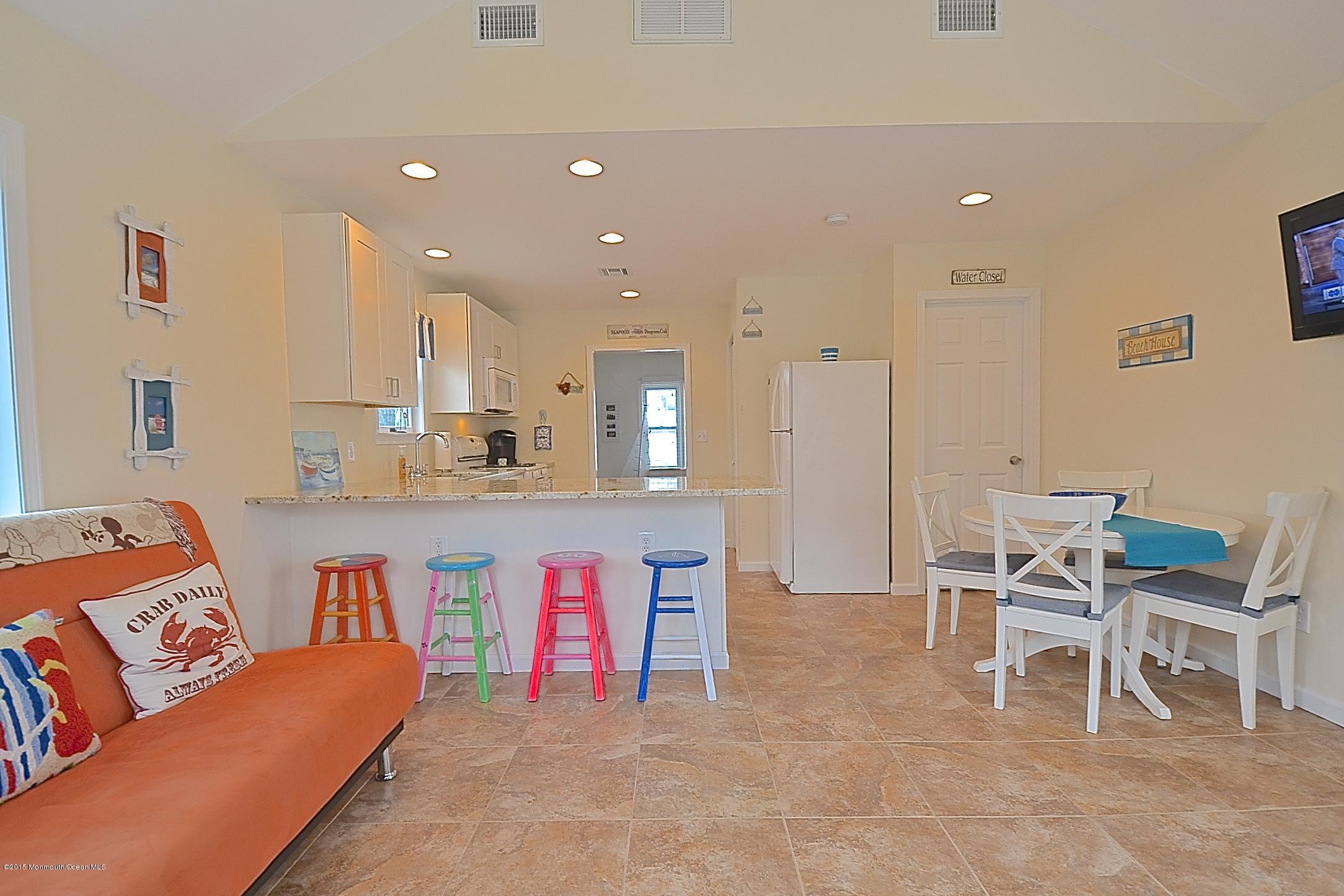 45 North Island Road Bayville, NJ 08721 - Photo 11 of 31 a living room with kitchen island furniture and a view of kitchen