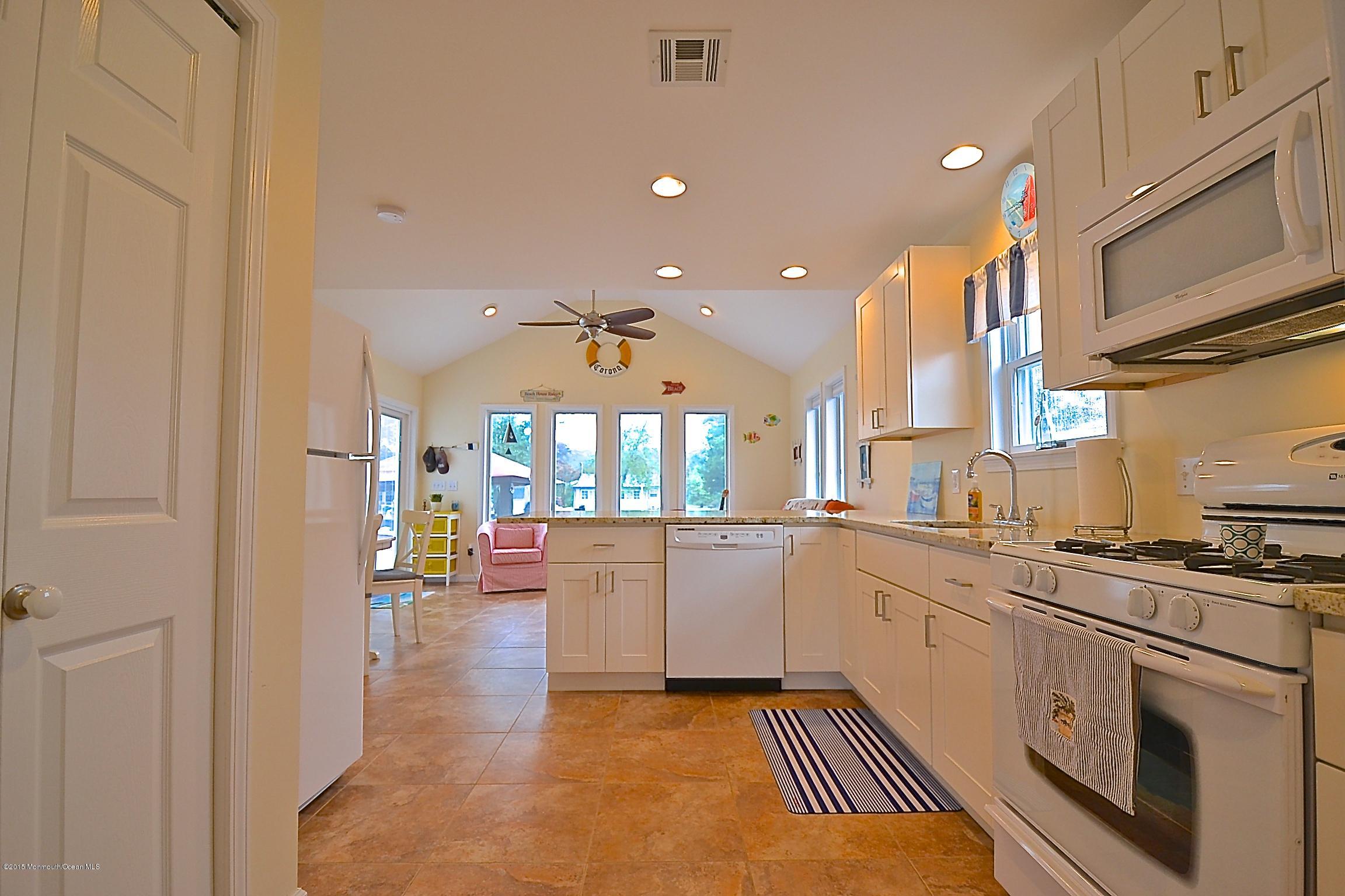 45 North Island Road Bayville, NJ 08721 - Photo 2 of 31 a kitchen with stainless steel appliances granite countertop a sink and cabinets