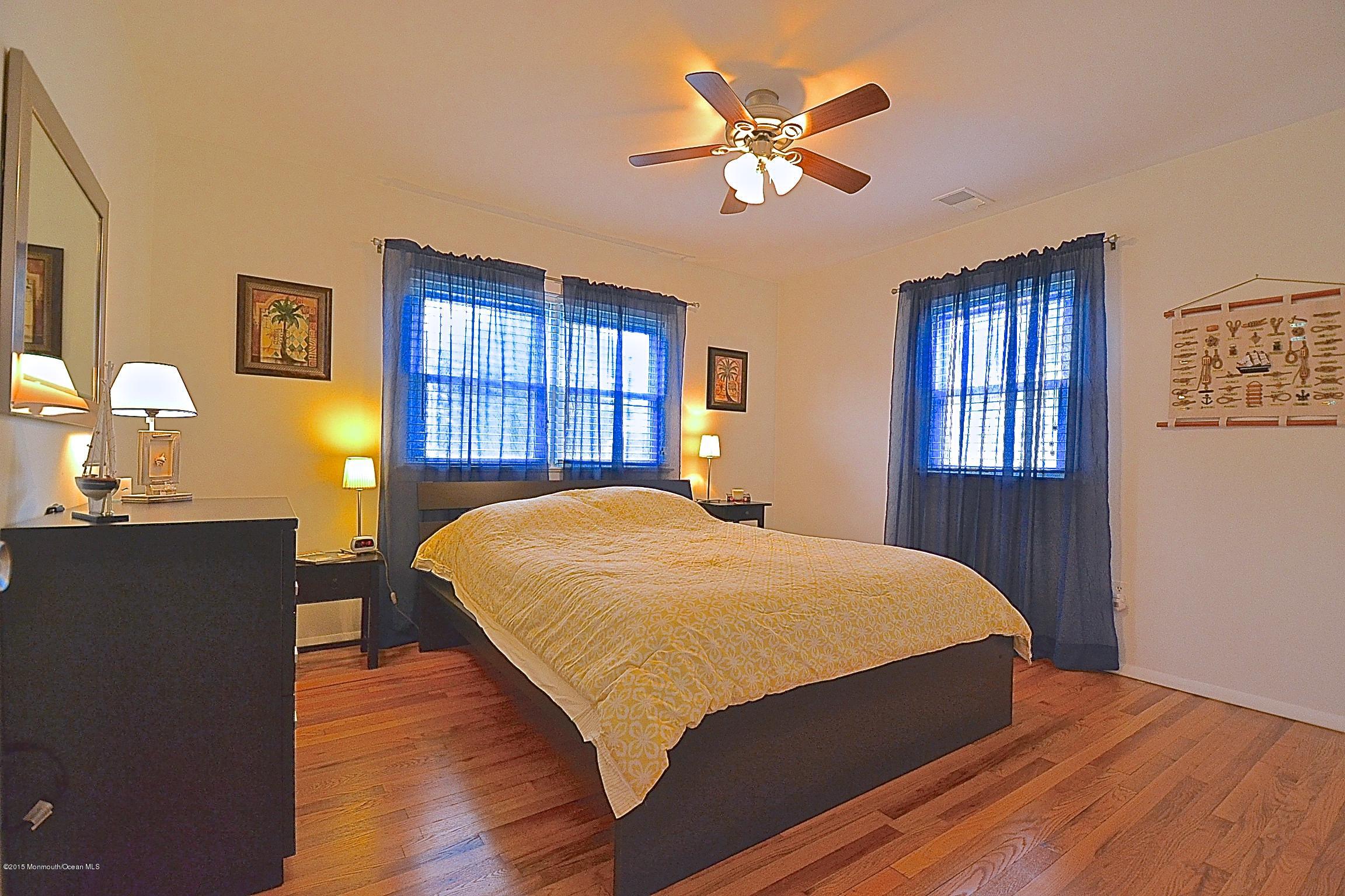 45 North Island Road Bayville, NJ 08721 - Photo 21 of 31 a bedroom with a bed and a chandelier