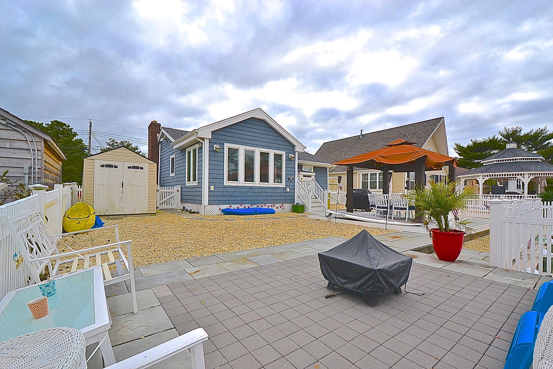 45 North Island Road Bayville, NJ 08721 - Photo 25 of 31 a front view of a house with swimming pool having outdoor seating