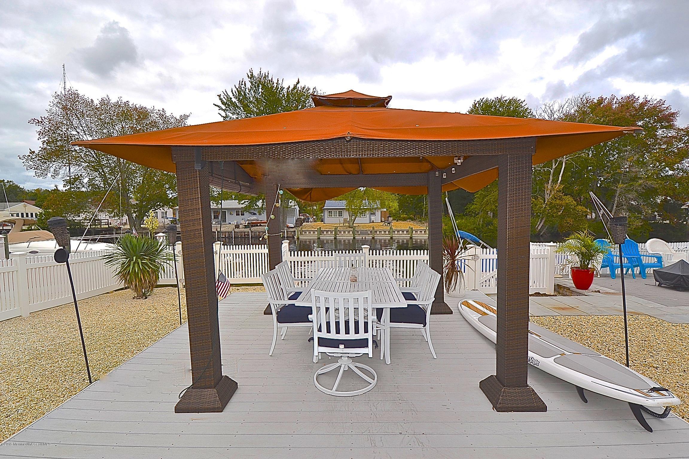 45 North Island Road Bayville, NJ 08721 - Photo 26 of 31 a patio with a yard table and chairs