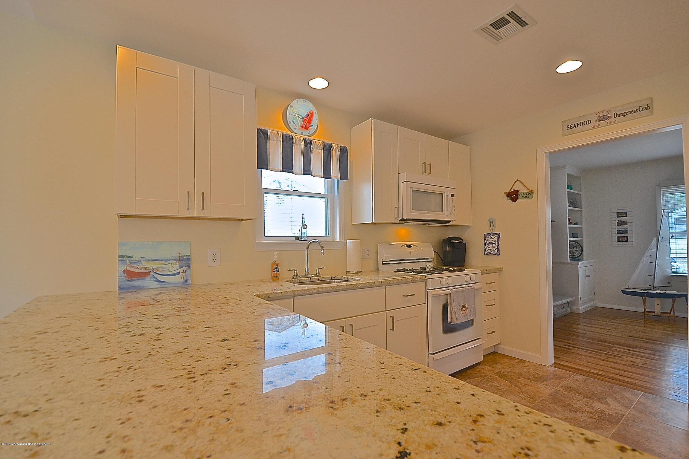 45 North Island Road Bayville, NJ 08721 - Photo 3 of 31 a kitchen with stainless steel appliances granite countertop a sink stove and cabinets
